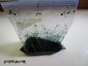 Add rice, water and black food coloring to a plastic bag and mix