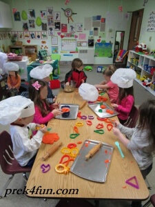 Chefs at work! Orange scented Play dough and vegetable / fruit shaped cookie cutters!